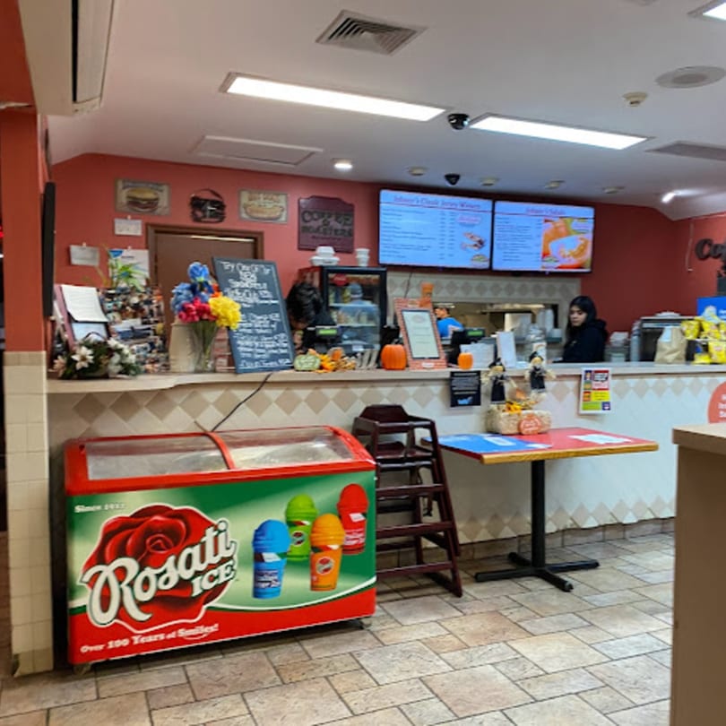 Interior of Jersey Johnny's Grill with a counter, menu screens, and a Rosati Ice freezer.